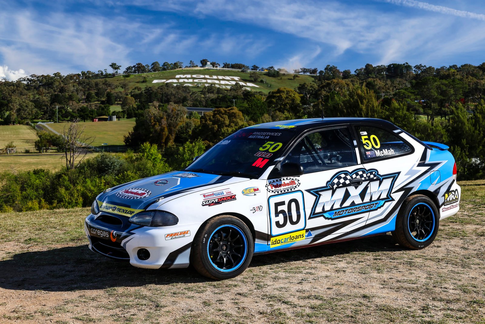 Car 50 parked below the Mount Panorama sign at Bathurst.